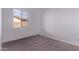 Bright bedroom featuring neutral carpet and a window letting in natural light at 20274 W Monterey Way, Buckeye, AZ 85396