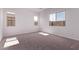 Bright bedroom featuring three windows and neutral colored carpeting at 20274 W Monterey Way, Buckeye, AZ 85396