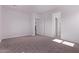 Neutral bedroom featuring gray carpet and a door leading to the bathroom at 20274 W Monterey Way, Buckeye, AZ 85396