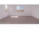 Sunlit bedroom with neutral carpet and view of the backyard at 20274 W Monterey Way, Buckeye, AZ 85396