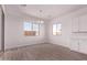 Bright dining room area with two windows, wood-look tile floors, and stylish chandelier at 20274 W Monterey Way, Buckeye, AZ 85396