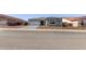 Charming single-story home featuring desert landscaping, a brick driveway, and a gray color scheme at 20274 W Monterey Way, Buckeye, AZ 85396