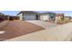 Home showcasing a spacious driveway and desert landscaping at 20274 W Monterey Way, Buckeye, AZ 85396