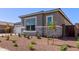 Close up of home showcasing manicured landscaping, stone accents, and neutral color scheme at 20274 W Monterey Way, Buckeye, AZ 85396