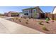 Street view of home featuring rock landscaping, desert foliage, and neutral color scheme at 20274 W Monterey Way, Buckeye, AZ 85396