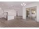 Open living space featuring wood-look tile floors, a sliding glass door, and a kitchen with stainless appliances at 20274 W Monterey Way, Buckeye, AZ 85396