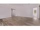 Spacious living area featuring wood-look tile floors, recessed lighting, and a modern minimalist aesthetic at 20274 W Monterey Way, Buckeye, AZ 85396