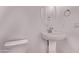 Powder room featuring a pedestal sink, oval mirror, updated fixtures, and a standard toilet at 20274 W Monterey Way, Buckeye, AZ 85396