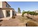 The backyard features desert landscaping, decorative rock features, and a covered patio at 20473 W Legend Trl, Buckeye, AZ 85396
