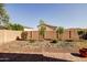 This backyard has desert landscaping, a brick wall, and mature plants at 20473 W Legend Trl, Buckeye, AZ 85396
