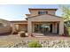 The backyard features desert landscaping, a covered patio, and privacy at 20473 W Legend Trl, Buckeye, AZ 85396