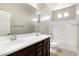 Bathroom featuring double sinks, and a shower-over-tub combination at 20473 W Legend Trl, Buckeye, AZ 85396