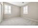 Bright bedroom with neutral walls, carpet, and natural light from shuttered windows at 20473 W Legend Trl, Buckeye, AZ 85396