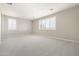 Spacious bedroom with carpet flooring and two shuttered windows allowing for natural light at 20473 W Legend Trl, Buckeye, AZ 85396