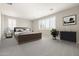 Spacious bedroom with neutral carpet, shutters, and a wood bed frame at 20473 W Legend Trl, Buckeye, AZ 85396