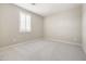Empty bedroom with neutral carpet, shuttered windows and ample natural light at 20473 W Legend Trl, Buckeye, AZ 85396