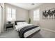 Modern bedroom with white shutters, neutral walls, and stylish decor creates a serene and inviting space at 20473 W Legend Trl, Buckeye, AZ 85396