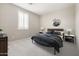 Comfortable bedroom with neutral carpet, shutters, side tables with lamps, and unique wall art at 20473 W Legend Trl, Buckeye, AZ 85396