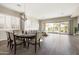 Open dining area features bright neutral tones, chandelier, and adjacent access to the backyard at 20473 W Legend Trl, Buckeye, AZ 85396