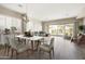 Elegant dining room featuring a modern table, comfortable chairs, and sliding glass doors to the backyard at 20473 W Legend Trl, Buckeye, AZ 85396