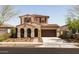 Charming two-story home featuring a tile roof, covered porch, and a two-car garage, perfect for Gathering living at 20473 W Legend Trl, Buckeye, AZ 85396