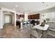 Open-concept kitchen featuring dark wood cabinets, a center island with seating, and stainless steel appliances at 20473 W Legend Trl, Buckeye, AZ 85396