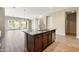 Kitchen island featuring a sink, stainless steel dishwasher, and ample counter space, perfect for meal preparation at 20473 W Legend Trl, Buckeye, AZ 85396