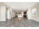 Open-concept living room with a modern kitchen featuring a large island and wood-look tile flooring at 20473 W Legend Trl, Buckeye, AZ 85396