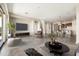 Spacious living room with a large TV, comfortable seating, and an open layout connecting to the dining area at 20473 W Legend Trl, Buckeye, AZ 85396