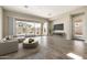 Spacious living room with a sliding glass door, neutral decor, and tiled floors at 20473 W Legend Trl, Buckeye, AZ 85396
