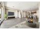 Open-concept living area showcases a TV, tile floors, neutral tones, and smooth transitions to dining at 20473 W Legend Trl, Buckeye, AZ 85396