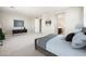 Large main bedroom features neutral carpeting, a TV, and seamless access to the bathroom at 20473 W Legend Trl, Buckeye, AZ 85396