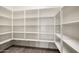 Walk-in pantry with ample shelving, providing organized storage space for all your kitchen essentials and supplies at 20473 W Legend Trl, Buckeye, AZ 85396