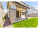 Backyard patio with artificial grass and stone pillars offers low-maintenance outdoor living space at 2205 N Peden Dr, Chandler, AZ 85225