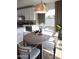 Cozy dining area features a modern light fixture, seating for six, and access to the kitchen at 2205 N Peden Dr, Chandler, AZ 85225