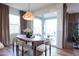 Cozy dining area features a modern light fixture, seating for six, and access to the backyard at 2205 N Peden Dr, Chandler, AZ 85225