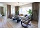 Bright living room with large windows, modern furniture, and stylish decor with beautiful hardwood flooring at 2205 N Peden Dr, Chandler, AZ 85225