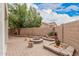 Brick-paved backyard with a fire pit, flower beds, and greenery at 2308 S Bernard --, Mesa, AZ 85209