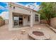 The home's backyard has a covered patio with a view to the fire pit and the mature trees at 2308 S Bernard --, Mesa, AZ 85209