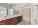 Bathroom featuring double sink vanity, large mirror, and tub with shower at 2308 S Bernard --, Mesa, AZ 85209