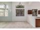 Well-lit dining area featuring neutral tile floors, a mirrored wall, and an updated chandelier at 2308 S Bernard --, Mesa, AZ 85209