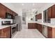 Updated kitchen featuring stainless steel appliances, dark wood cabinets and a seamless view into the dining area at 2308 S Bernard --, Mesa, AZ 85209