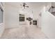Bright living room showcasing neutral tile floors, fireplace, ceiling fan and view into the kitchen at 2308 S Bernard --, Mesa, AZ 85209