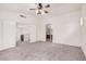 Spacious main bedroom with carpet, ceiling fan, and en suite bathroom at 2308 S Bernard --, Mesa, AZ 85209
