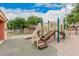Community playground featuring modern play structure with slides and stairs set in a fenced common area at 2308 S Bernard --, Mesa, AZ 85209