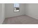 A cozy bedroom with plush carpet and a view through the window at 23443 W Albeniz Pl, Buckeye, AZ 85326