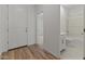 Bright entryway with wood floors leading to the bathroom and bedroom at 23443 W Albeniz Pl, Buckeye, AZ 85326