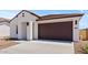 Charming single-story home featuring a two-car garage, desert landscaping, and a modern facade at 23443 W Albeniz Pl, Buckeye, AZ 85326