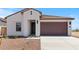Charming single-story home featuring a two-car garage, desert landscaping, and a modern facade at 23443 W Albeniz Pl, Buckeye, AZ 85326