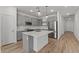 Open kitchen features an island, pendant lighting, and stainless steel appliances at 23443 W Albeniz Pl, Buckeye, AZ 85326